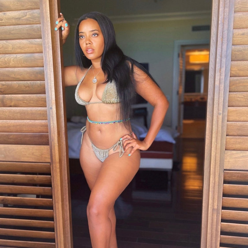 Model and Fashion Designer Angela Simmons Standing In The Doorway of a tropical villa wearing a sparkly gold bikini by Vanity Couture