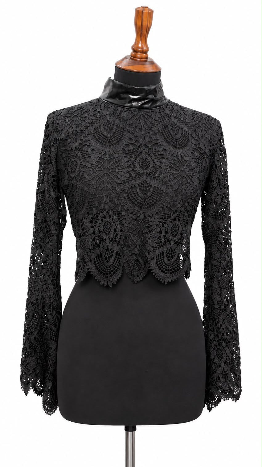 Black sheer lace top with faux leather mock neck and flared lace sleeves on a dress form