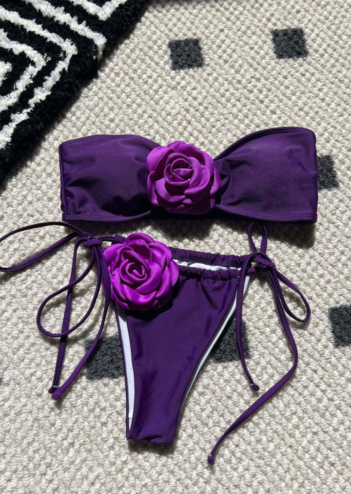Purple bikini set with floral details on a checkered floor