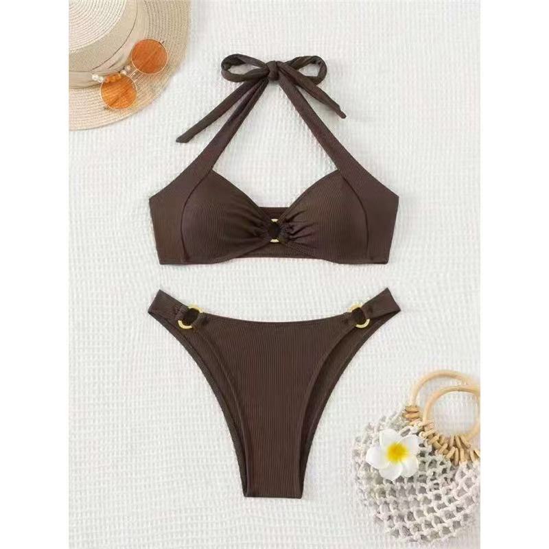 Brown bikini set with matching accessories on a white background