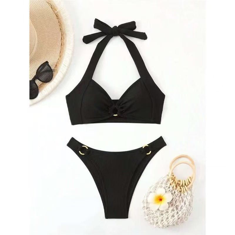 Black bikini set with a straw hat and bag on a white background