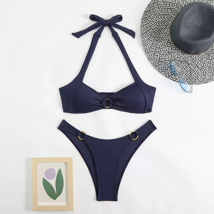 Navy blue bikini set with a matching hat on a white background